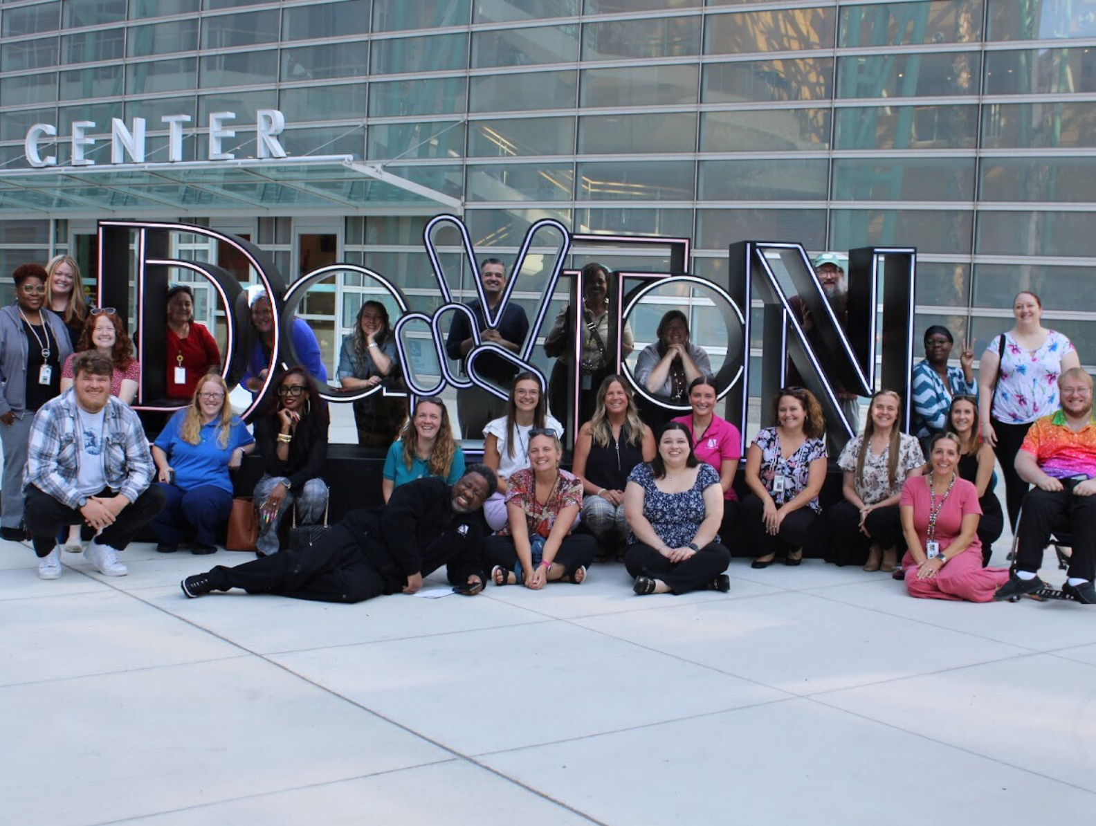 Area Agency on Aging staff posing in front of the Dayton Peace sign.